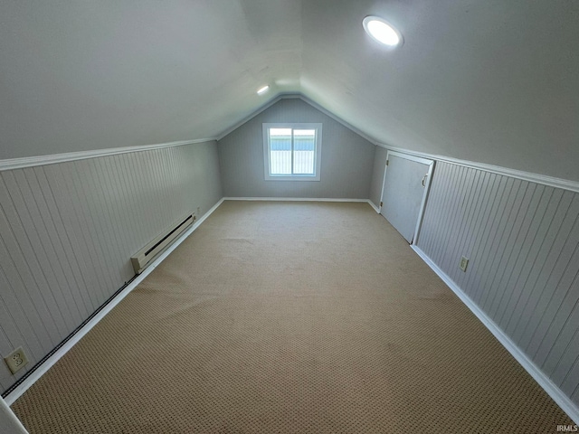 additional living space featuring carpet flooring, vaulted ceiling, and baseboard heating