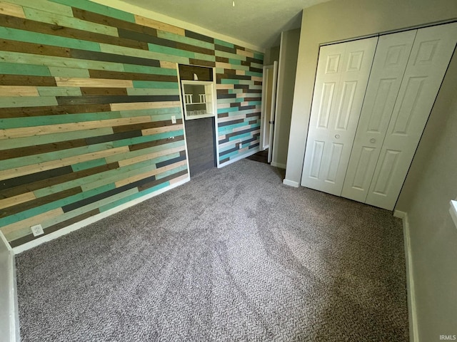 unfurnished bedroom featuring carpet and a closet