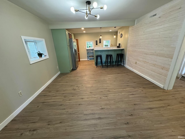 interior space with hardwood / wood-style flooring and an inviting chandelier