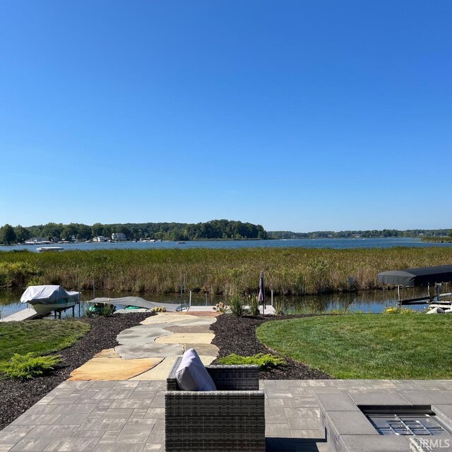 exterior space with a lawn and a water view