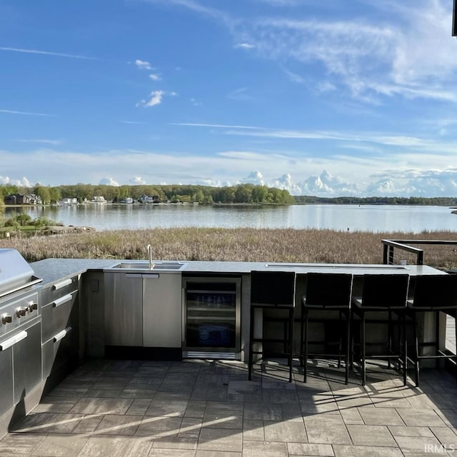 135 Ln 850 Snow Lk, Fremont, IN 46737 - view of patio with wine cooler, an outdoor bar, a water view, and area for grilling