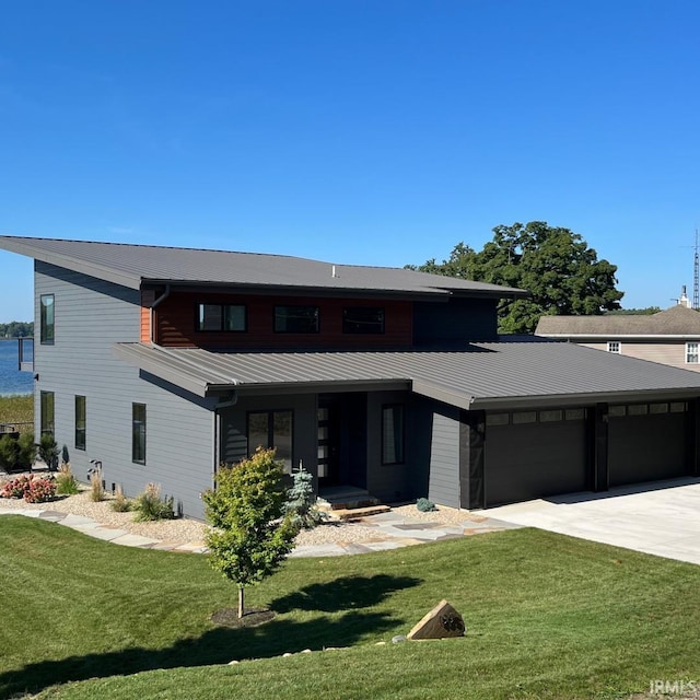 view of front of home with a garage and a front yard