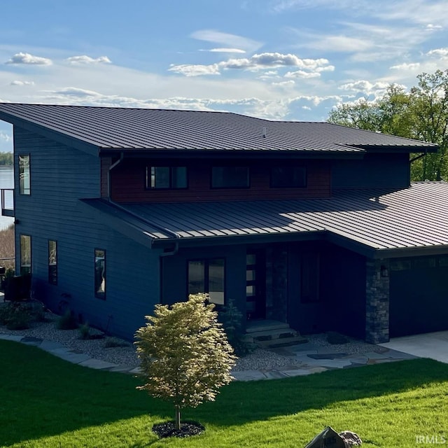 135 Ln 850 Snow Lk, Fremont, IN 46737 - view of front of house featuring a standing seam roof, metal roof, a front lawn, and a garage
