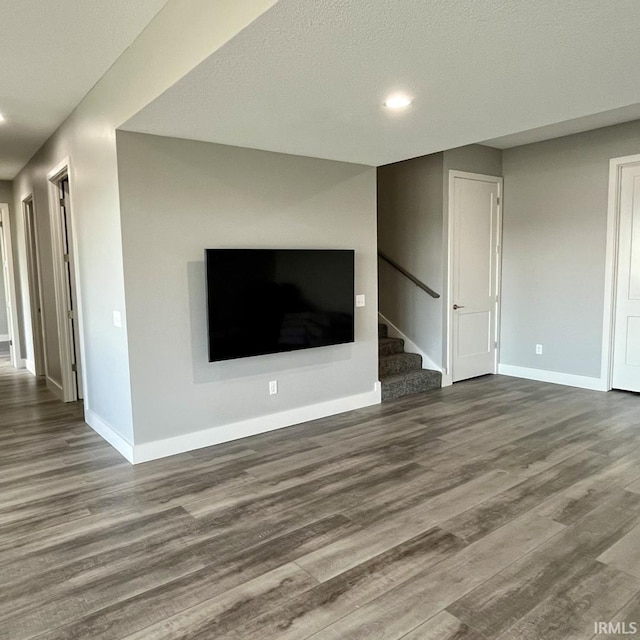 135 Ln 850 Snow Lk, Fremont, IN 46737 - unfurnished living room featuring wood finished floors, stairway, baseboards, and recessed lighting
