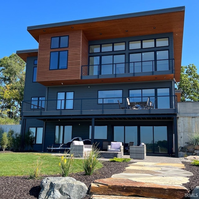 back of property with a patio, a balcony, and a yard