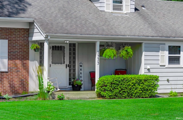 entrance to property with a lawn