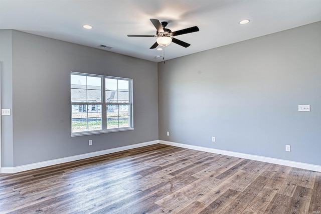 empty room with dark hardwood / wood-style floors and ceiling fan