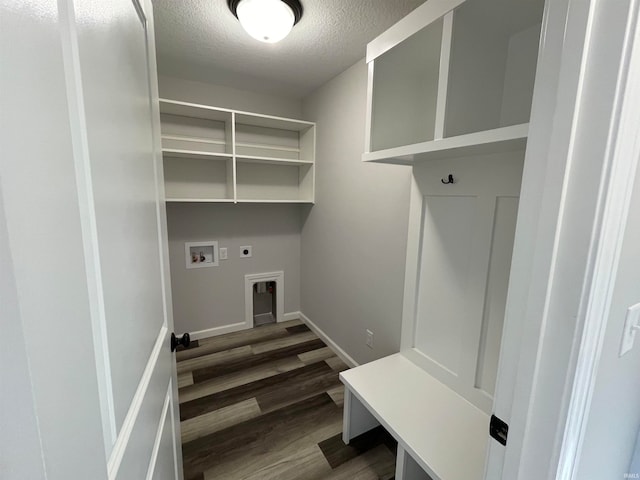 interior space featuring dark wood-type flooring and a textured ceiling