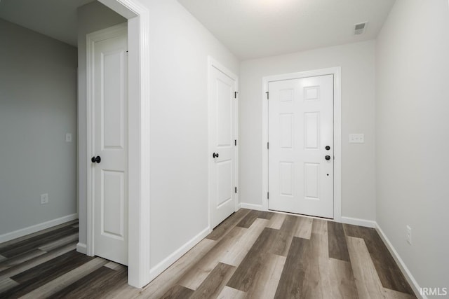 foyer entrance with dark hardwood / wood-style floors