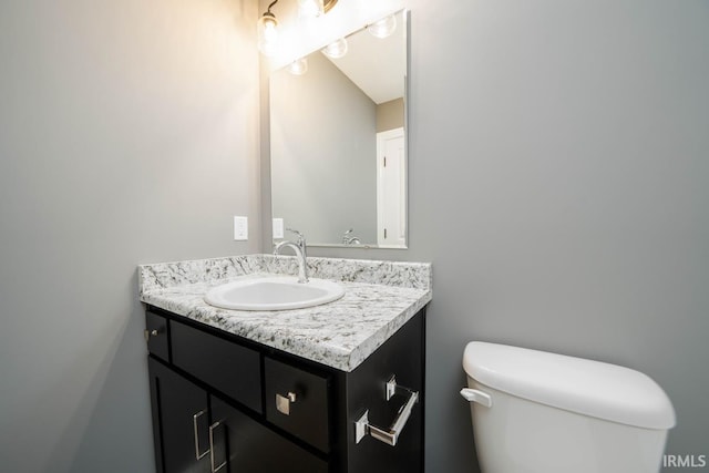 bathroom featuring toilet and vanity