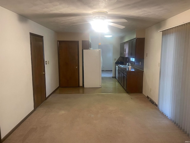 interior space featuring ceiling fan, sink, and light colored carpet