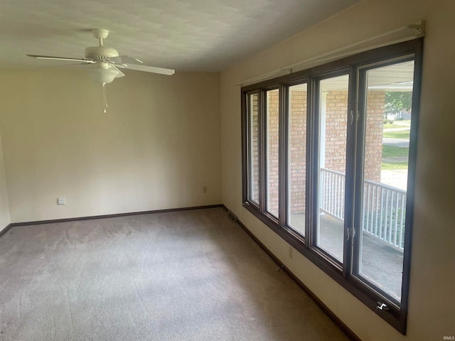 empty room with ceiling fan and carpet flooring