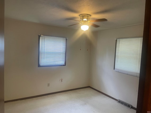 unfurnished room with carpet and ceiling fan