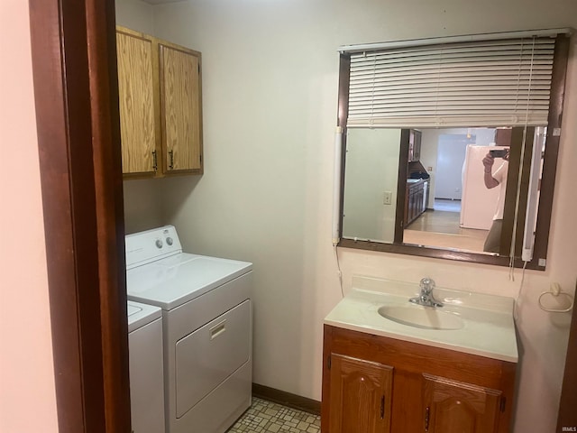 laundry room featuring sink, light tile patterned floors, and separate washer and dryer