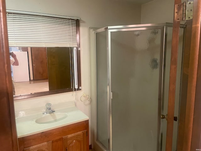 bathroom with an enclosed shower and vanity