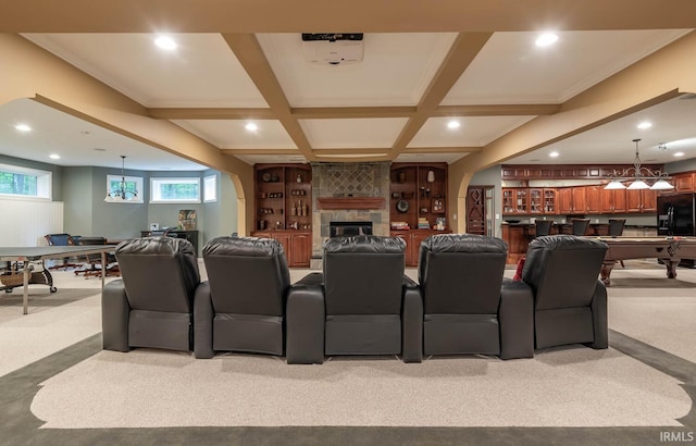 carpeted cinema with beamed ceiling, bar, and coffered ceiling