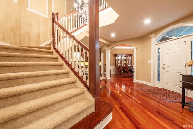 entrance foyer with hardwood / wood-style flooring and decorative columns