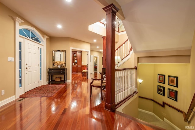 entrance foyer with decorative columns and wood-type flooring