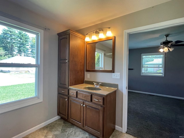 bathroom with plenty of natural light, vanity, ceiling fan, and tile patterned flooring