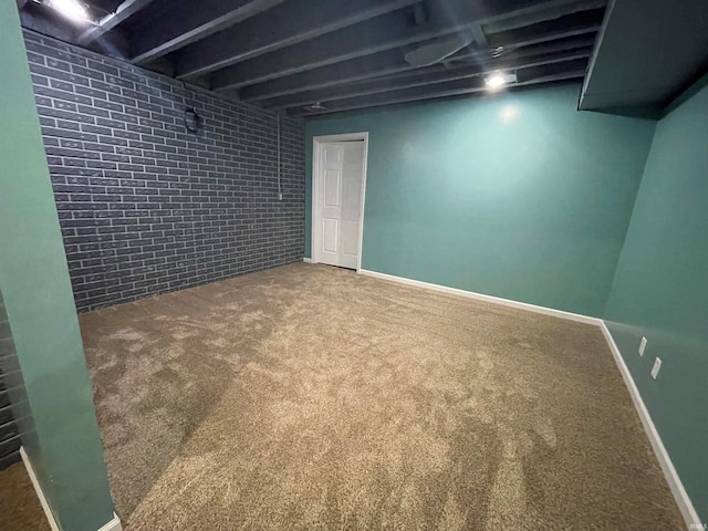 basement with brick wall and carpet