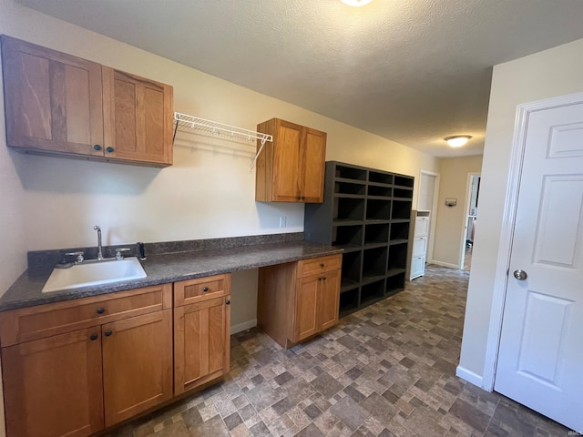 kitchen with dark tile patterned flooring and sink