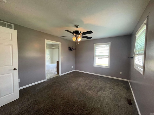 carpeted spare room featuring ceiling fan