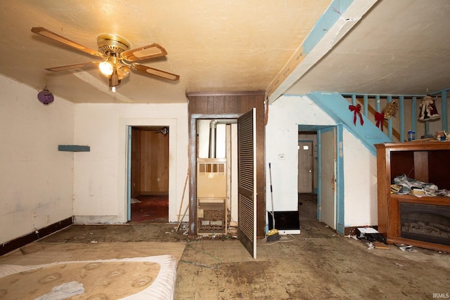 interior space with ceiling fan