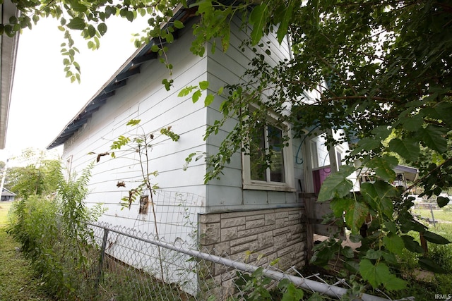 view of side of home featuring fence