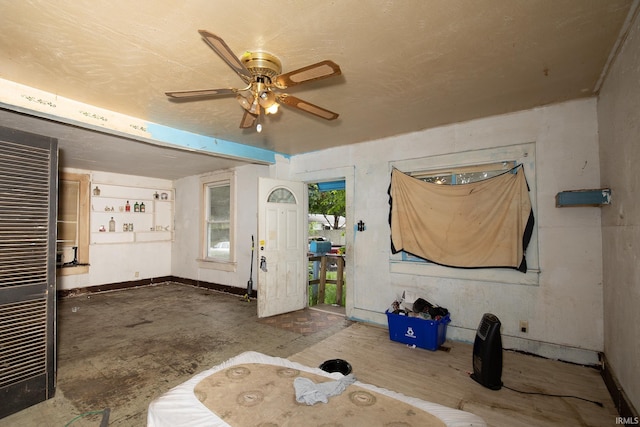 interior space with ceiling fan