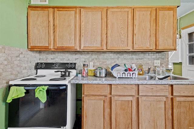 kitchen with light brown cabinetry, electric range, and decorative backsplash