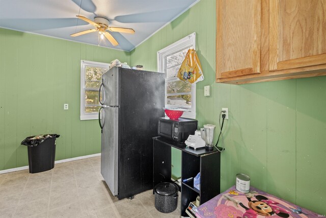 kitchen featuring ceiling fan, light brown cabinets, refrigerator, and light tile patterned floors