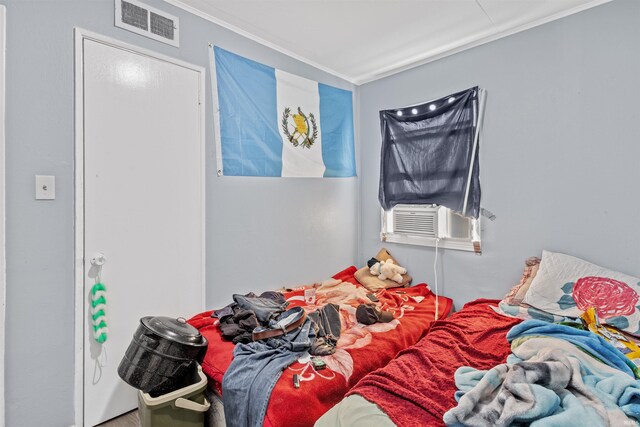 bedroom featuring ornamental molding and cooling unit