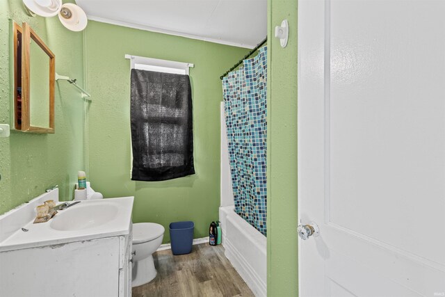 full bathroom featuring shower / bath combo with shower curtain, vanity, toilet, and hardwood / wood-style flooring