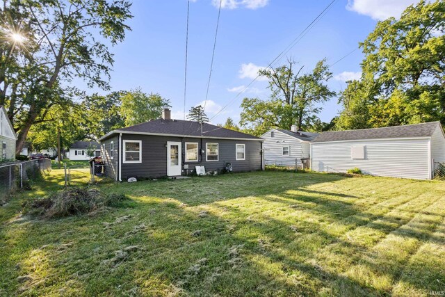 rear view of property with a yard