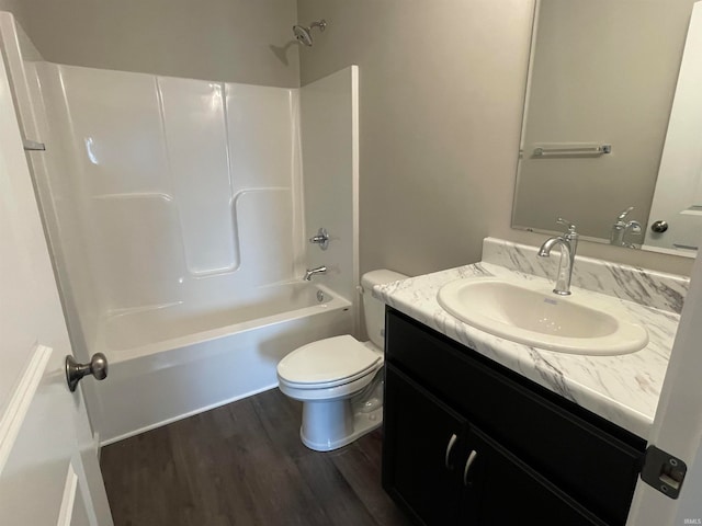 full bathroom featuring tub / shower combination, toilet, vanity, and hardwood / wood-style flooring