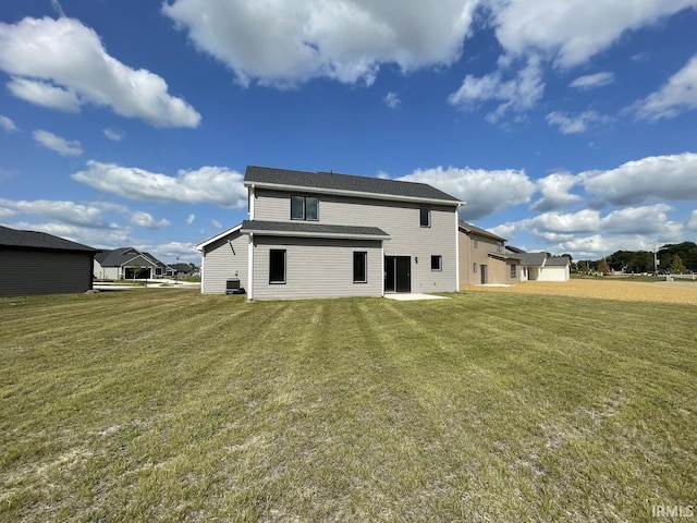 rear view of property with a lawn