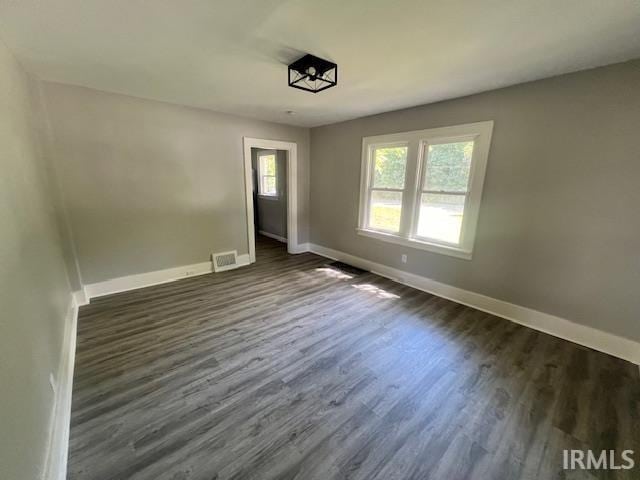 spare room with dark hardwood / wood-style flooring