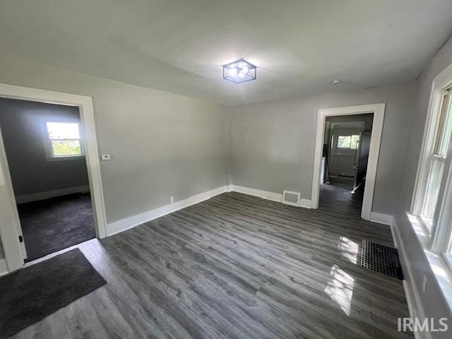 spare room with dark wood-type flooring