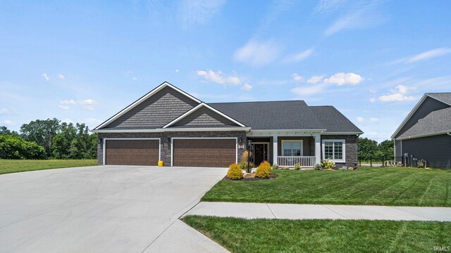 craftsman inspired home featuring a lawn and a garage