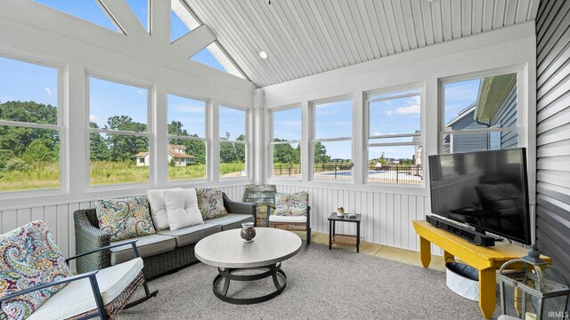 sunroom / solarium featuring lofted ceiling with skylight