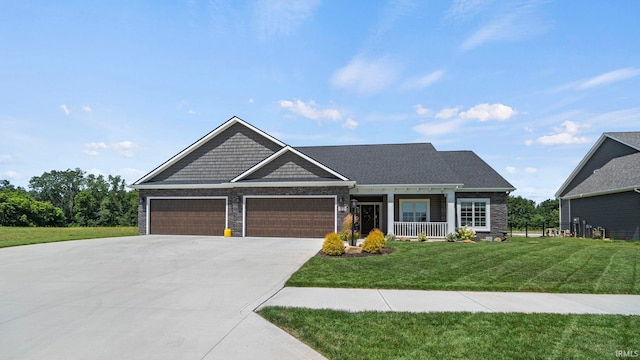 craftsman house featuring a front yard and a garage