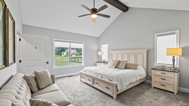 carpeted bedroom with ceiling fan, high vaulted ceiling, and beam ceiling