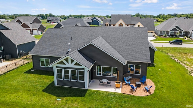 rear view of property with a patio and a yard