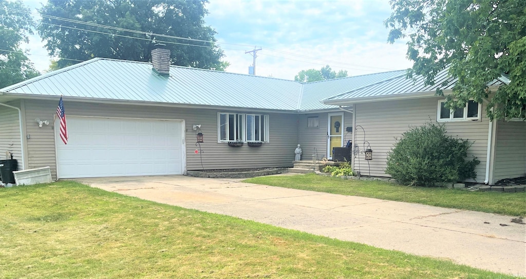 single story home featuring a garage and a front lawn