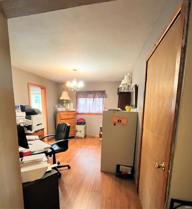 office space with a notable chandelier and hardwood / wood-style flooring