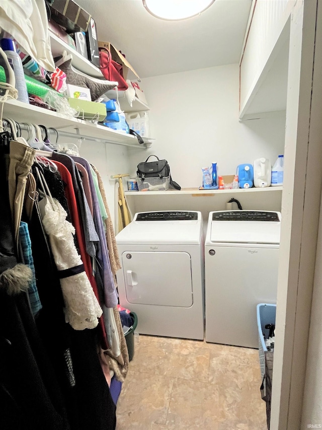 laundry room with washing machine and dryer and light tile patterned floors