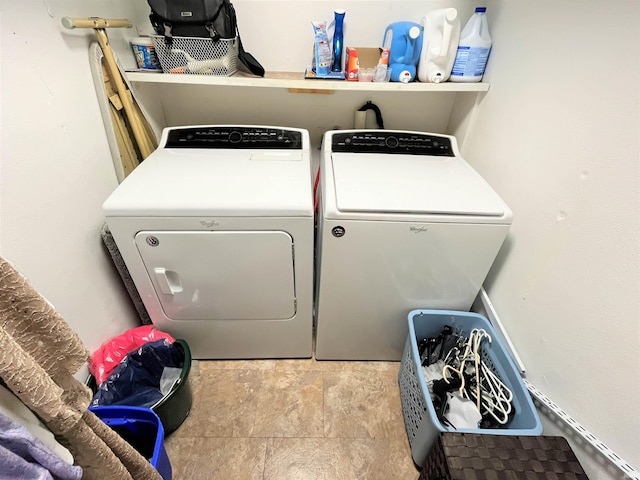 washroom with washer and dryer and light tile patterned flooring