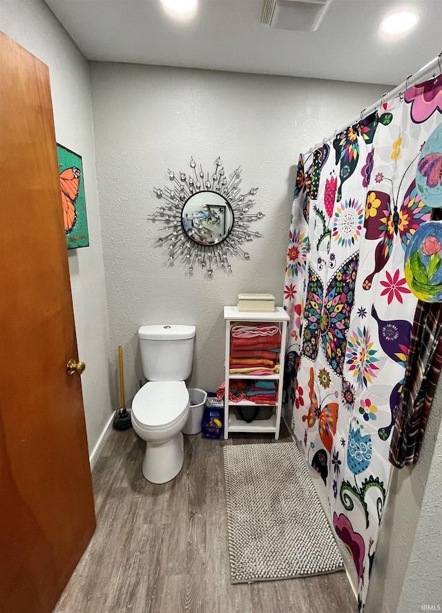 bathroom featuring toilet and hardwood / wood-style floors