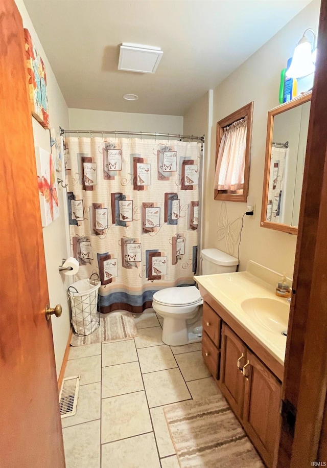 bathroom featuring vanity, tile patterned flooring, and toilet