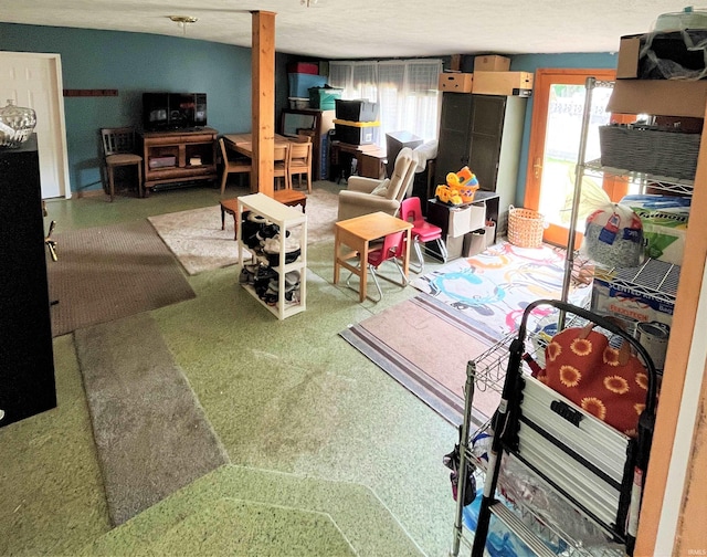 carpeted living room featuring a textured ceiling